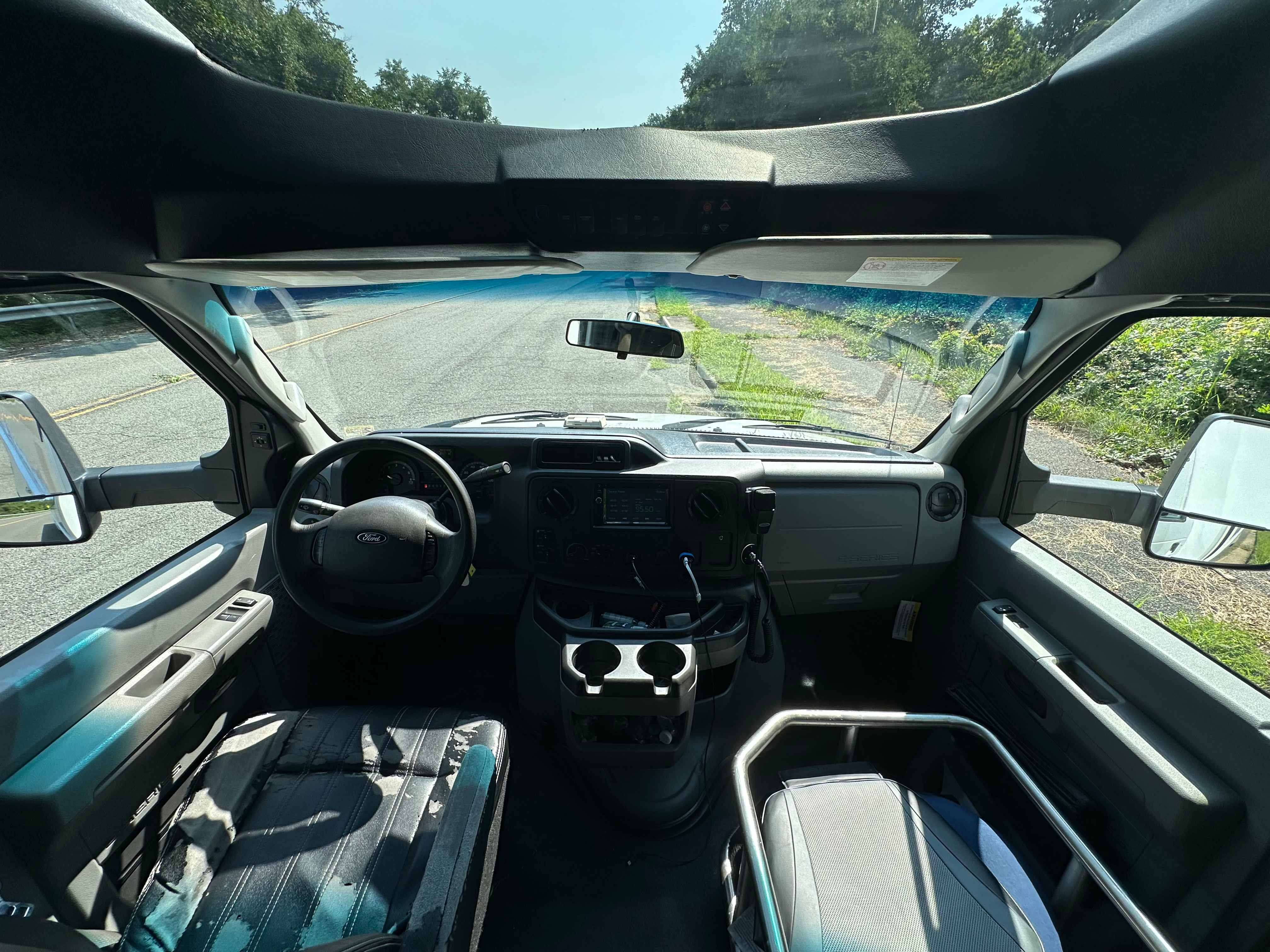 Mini coach bus driver cockpit view through the windshield