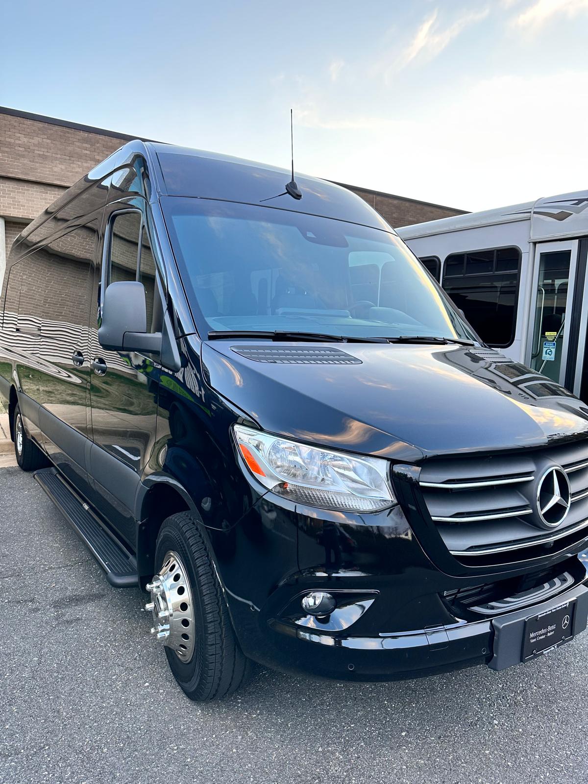 Black Mercedes-Benz Sprinter passenger van, front three-quarter exterior view