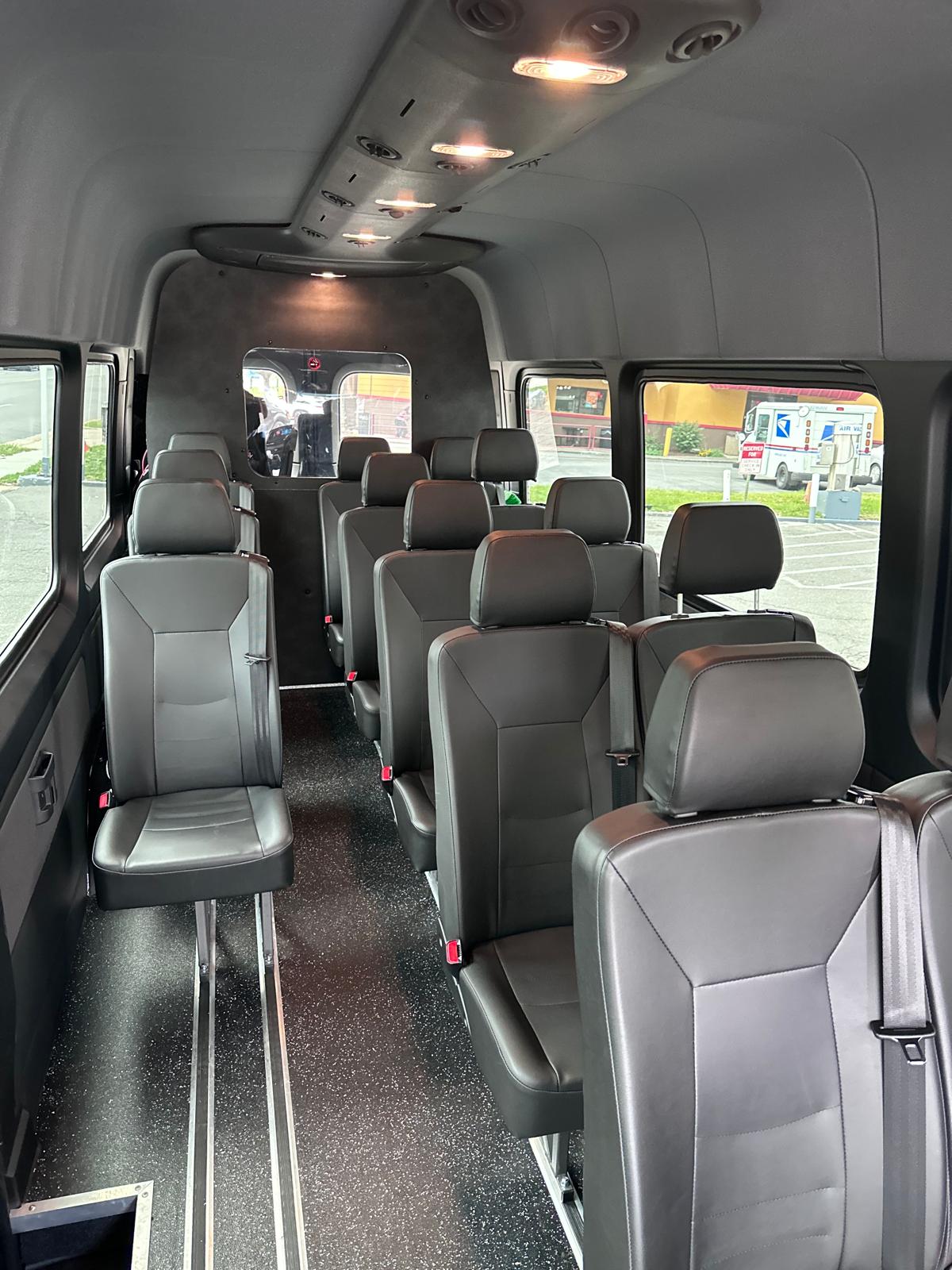 Mercedes-Benz Sprinter van interior with rows of black leather passenger seats